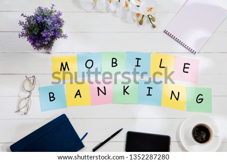 MOBILE BANKING. Message at colorful note papers on a desk background. Lifestyle, business, office, finance, plan, success, bank and management concept. Top or flat lay view.