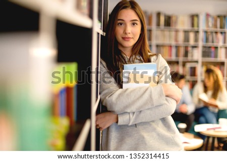 Beautiful female student in library