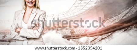 Portrait of confident businesswoman standing with arms crossed against computer graphic image of stadium