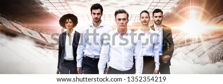 Confident business people walking against white background against digitally generated image of stadium
