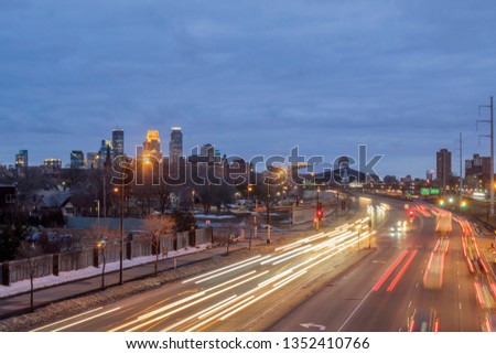 A Long Exposure Cityscape Shot of Traffic Passing Through Minneapolis During a Cloudy Spring Twilight
