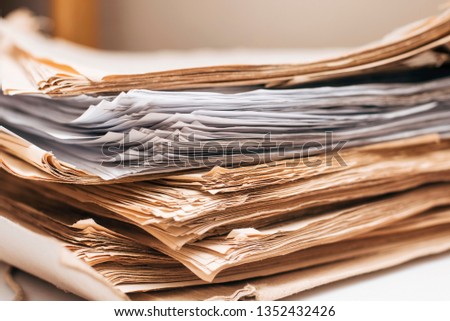 Beautiful paper background - old sheets of paper lie on one another. The paper is folded and will later be taken away for recycling to produce new paper. Recycling concept