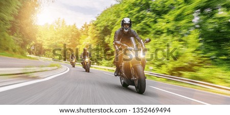 motorbiker on the forest road riding. having fun driving the empty road on a motorcycle tour journey. copyspace for your individual text. Royalty-Free Stock Photo #1352469494