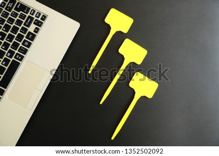 Laptop Keyboard and Empty Yellow Labels isolated on Black Background