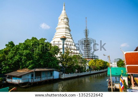 Maharatchamongkhon stupa and the structure of unfinished big Buddha image in Wat Paknam Bhasicharoen, viewed from Klong Dan, Bangkok, thailand
