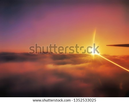 View from aeroplane's window ,sunset and clouds in the sky 