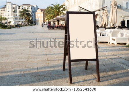 Blank white outdoor advertising stand, sandwich board mock up template. Clear street signage board placed inside modern building. Urban city, shopping center environment