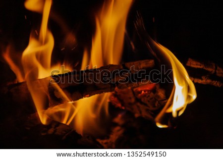 Mesmerizing and hypnotic closeup of fire flames from a bonfire, its embers and sparks