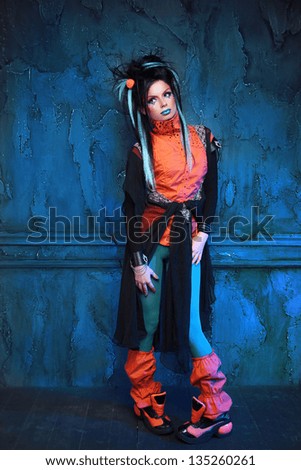 Full length Portrait of a punk girl posing grunge wall interior