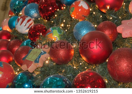 The view of Christmas and New Year decoration. Close up of colorful baubles on a christmas tree.
