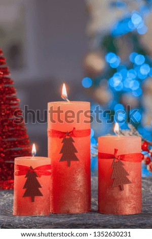 Christmas still life of home lighting candles with blue lights on background