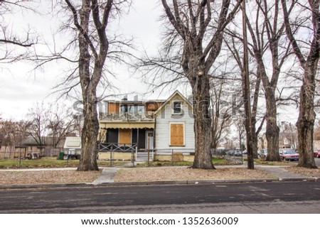 Abandoned Corner House With Boarded Up Windows