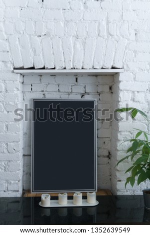 close up of cozy modern room with old chimney in white brick wall, new york loft with galerie poster placeholder, just blend in your photo here Royalty-Free Stock Photo #1352639549