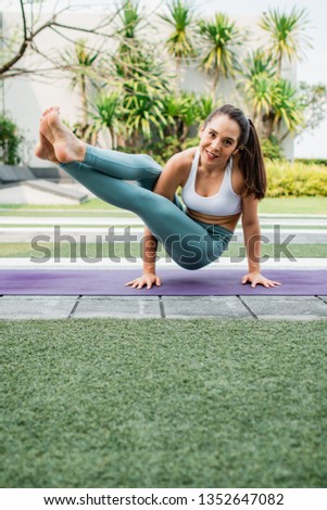 Beautiful Yoga teacher warm up before do Yoga practice. Portrait of young woman practice yoga outdoor.
