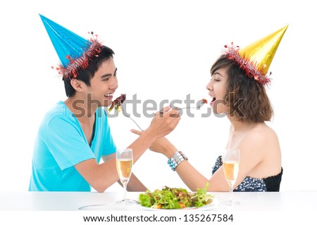Isolated image of a couple feeding each other