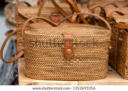 Famous Balinese rattan eco bags in a local souvenir market on street in Ubud, Bali, Indonesia. Handicrafts and souvenir shop display, close up