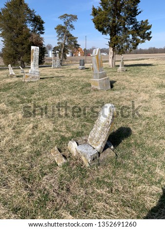 Old graveyard in the country with headstones faded from time