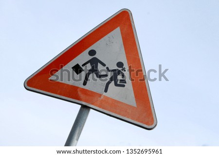 Damaged roadsign caution children crossing road near school