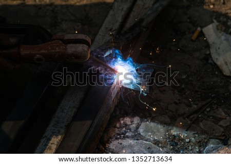 Hand hold welding steel. Renovation wooden house to new construction. Welds with argon-arc welding.