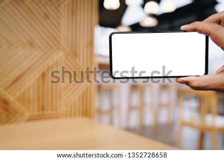 Man using Smartphone. Blank screen mobile phone for graphic display montage.