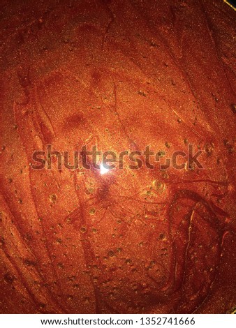Red gold paint (ink) with gold sparkle and waves background, gold bubble