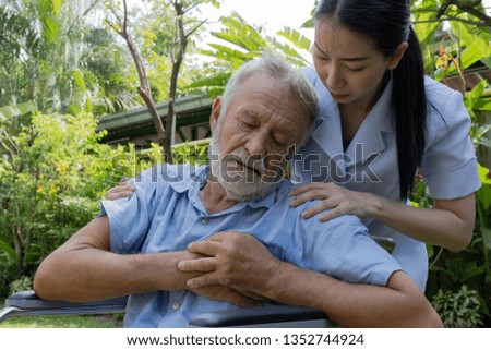 senior man happiness sitting on wheelchair and heart attack with nurse, takes care and discussion in the garden at nursing home