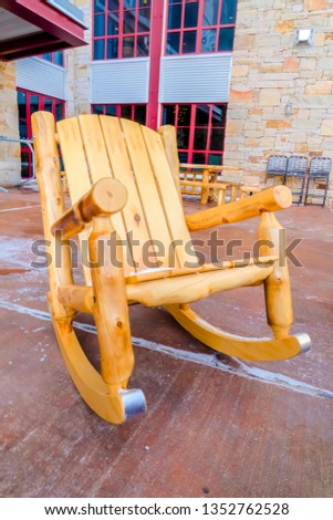 Wooden rocking chair on the patio of a building