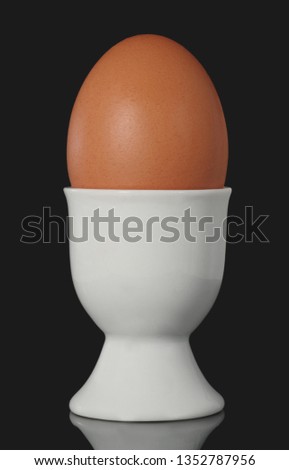Chicken Egg in Egg Cup Isolated on black Background