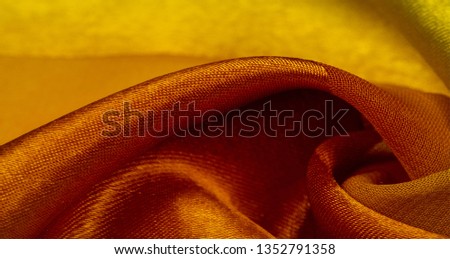 Texture, background, yellow silk striped fabric with a metallic sheen. If you have a bad mood, this fabric will lift it to unprecedented heights. Your project will be successful. Royalty-Free Stock Photo #1352791358