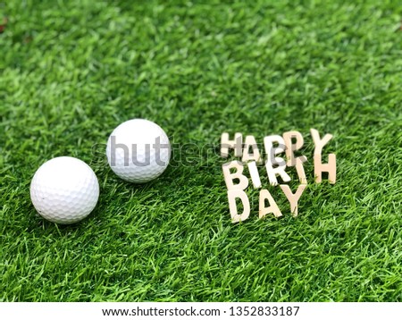 Happy Birthday to golfer with two golf balls are on green grass