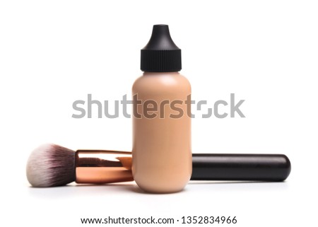 Close-up of flat makeup brush with liquid foundation tube isolated on white - Image