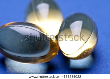 Cod liver oil omega 3 gel capsules isolated on pastel background