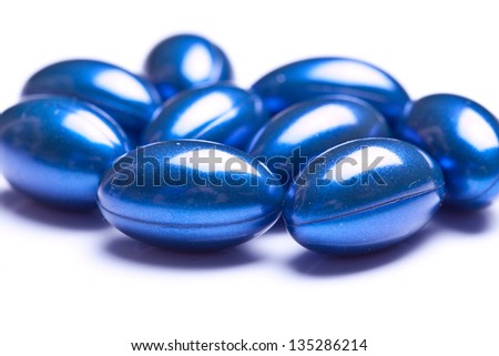 blue vitamin gel capsules isolated on pastel background