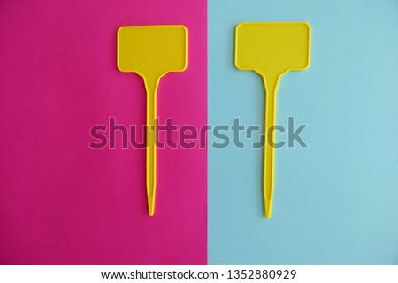 Empty Yellow Labels on Pink and Blue Background