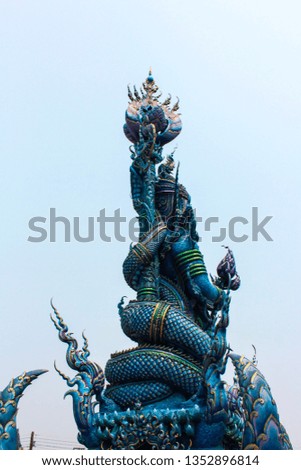 The giant half dragon half man sculpture in front of Blue temple, ChiangRai, Thailand