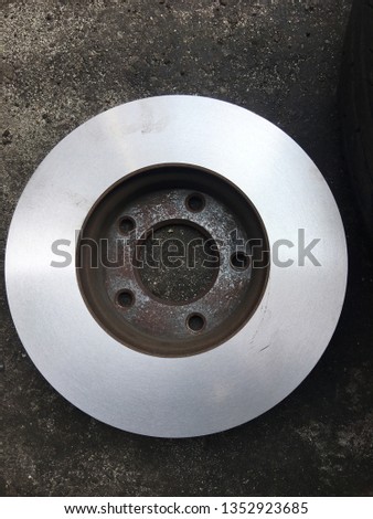 Closeup of car disc brake being serviced