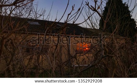 Picture taken 28th March // Reflection of a beautiful red glowing sunset on a window of what looks to be a workshop.