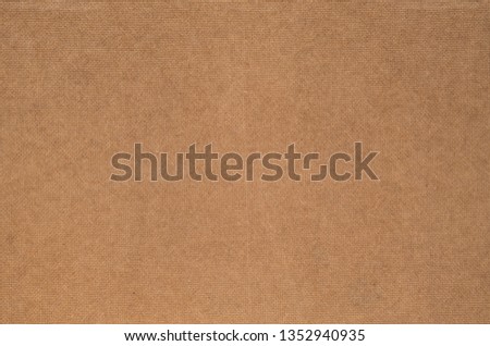 Close up rear side of brown plywood. Natural bumpy texture fiber material. Back view of compressed chipboard. Abstract dark background for wrapping paper, website template and greeting card backdrop.