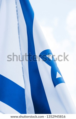 close up of national flag of israel against sky with clouds  
