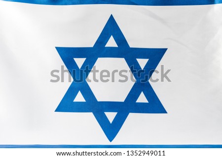 close up of blue star of david on national flag of israel 