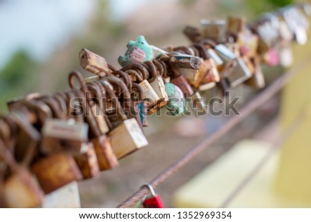 Lock for couple make a promise to love forever, master keys hanging on the rails of bridge, the sign of love and romantic affection as a landmark. Symbolic love locks hang along.