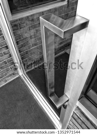 Blank glass door with door handle made of stainless steel.door hardware.picture style black and white