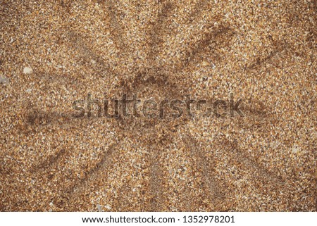 Symbols and signs are drawn on the sand