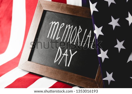 memorial day letters on chalkboard near national flag of america 