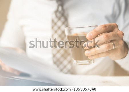 Light background. Young bearded businessman. Businessman Office work with computer on table in office work. Financial business. Work with a laptop.