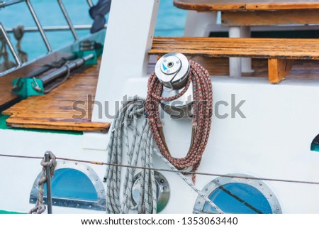 White yacht. Mooring and anchor ropes. Water transport. Black Sea. Mooring lines in front of a white yacht.