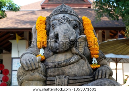 Sandstone Statue of Lord Ganesha with Flower Offering - The Hindu God of Success