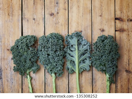 Kale super vegetable on a wooden background Royalty-Free Stock Photo #135308252