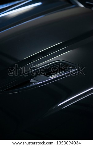 Back headlight of a modern luxury gray metallic car, auto detail, car care concept in the garage
