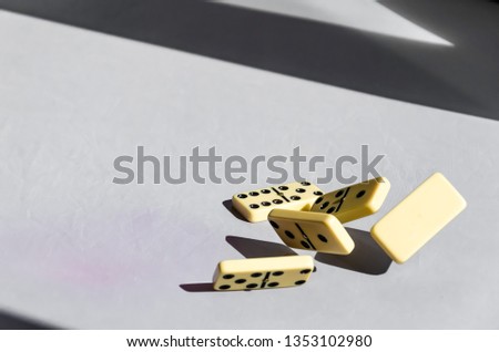 Five white dominoes hovering in the air on white background. Falling dominoes.